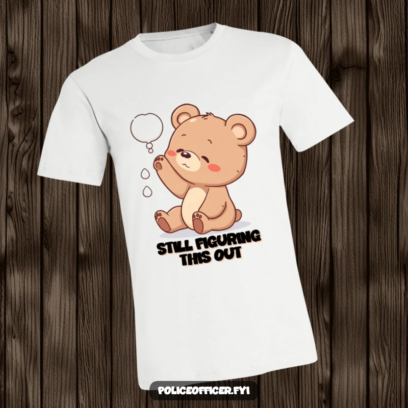 Funny bear cub t-shirt showing a small cub with a head tilt, reaching for a thought bubble, embodying curiosity and charm.